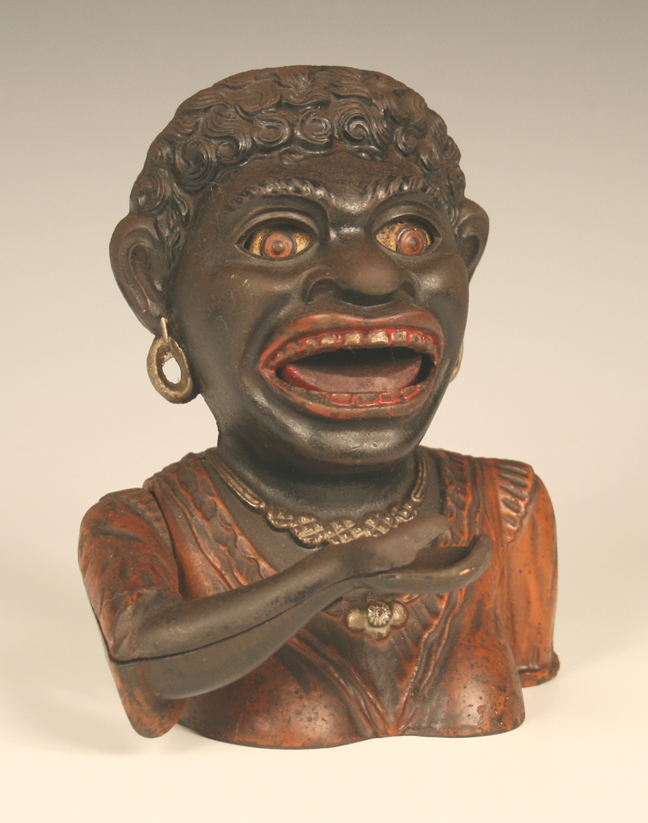 A Dinah cast iron money box, the back marked 'Rd. No. 561285'.