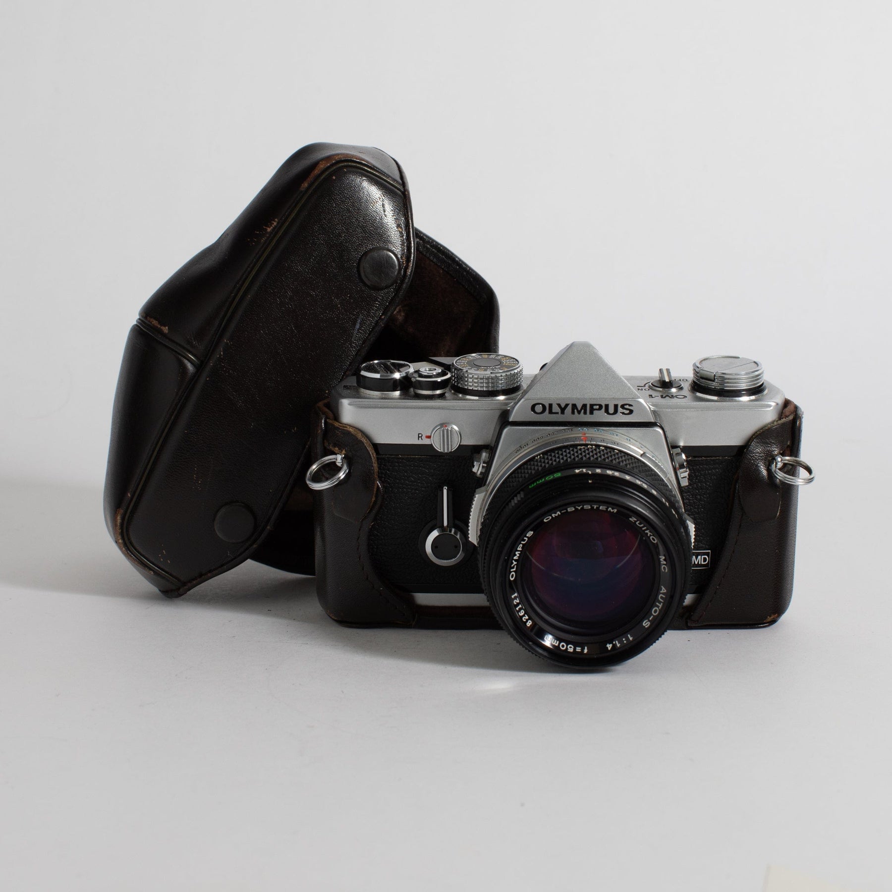 Olympus OM-1 with 50mm f/1.4 lens and leather case (film tested