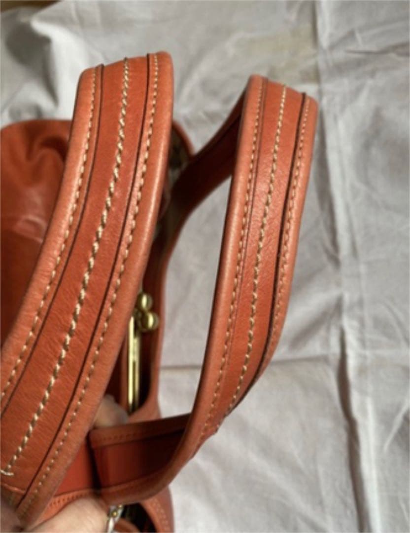 コーチ オレンジ エルゴレザープリーテッドフレームドサッチェル